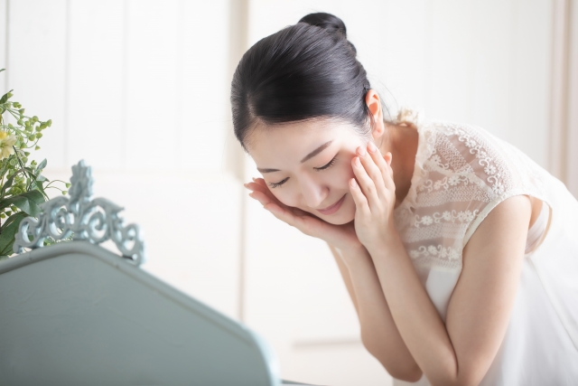 顔の肌の調子を調べる女性